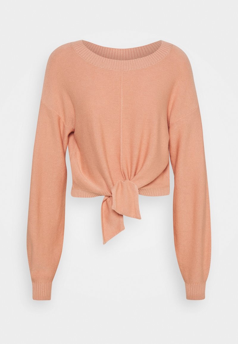 Pull en maille pêche clair à manches longues avec encolure ronde et nœud noué devant à la taille.