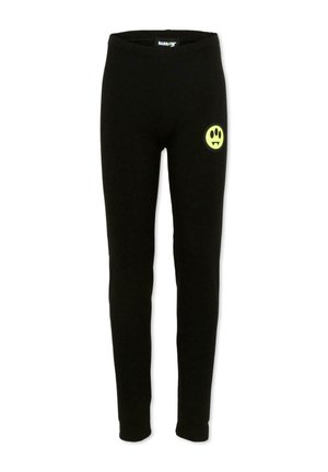Pantalon ajusté noir avec un petit visage souriant jaune muni de crocs de vampire sur la partie supérieure droite de la cuisse, taille élastique visible à l'intérieur.