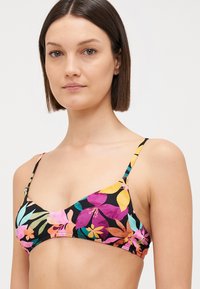 Triangular bikini top with multicolored floral pattern on a black background. Thin, adjustable straps and elasticated edges.