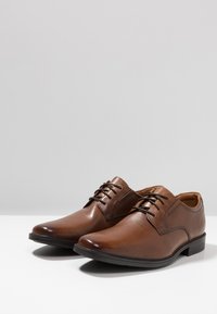 Braune Lederhalbschuhe mit glatter Oberfläche, runder Zehenform, Schnürdesign und niedrigem Absatz. Sie verfügen über eine detaillierte Naht und ein bequemes Innenleben.