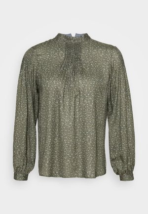 Blusa verde oliva a maniche lunghe con scollatura arricciata, parte anteriore plissettata e morbida texture glitterata. Maniche con polsini e elastico all'orlo.