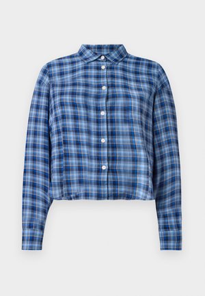 Blue and black plaid long-sleeve cropped shirt with pointed collar and white buttons down the front on a white background.