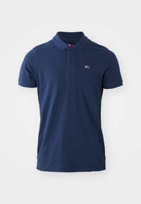 Navy blue polo shirt made from soft fabric, featuring a classic collar, three-button placket, and a small logo on the left chest.