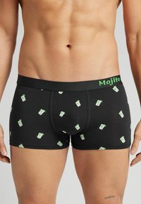 Černé boxerky s opakujícím se vzorem sklenic koktejlu mojito. Elastický pás s textem "Mojito" v zelené barvě. Měkká, hladká tkanina.