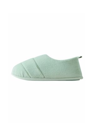 Light green slipper with a soft, textured fabric, featuring a rounded toe, slip-on design, and subtle diagonal stitching details.