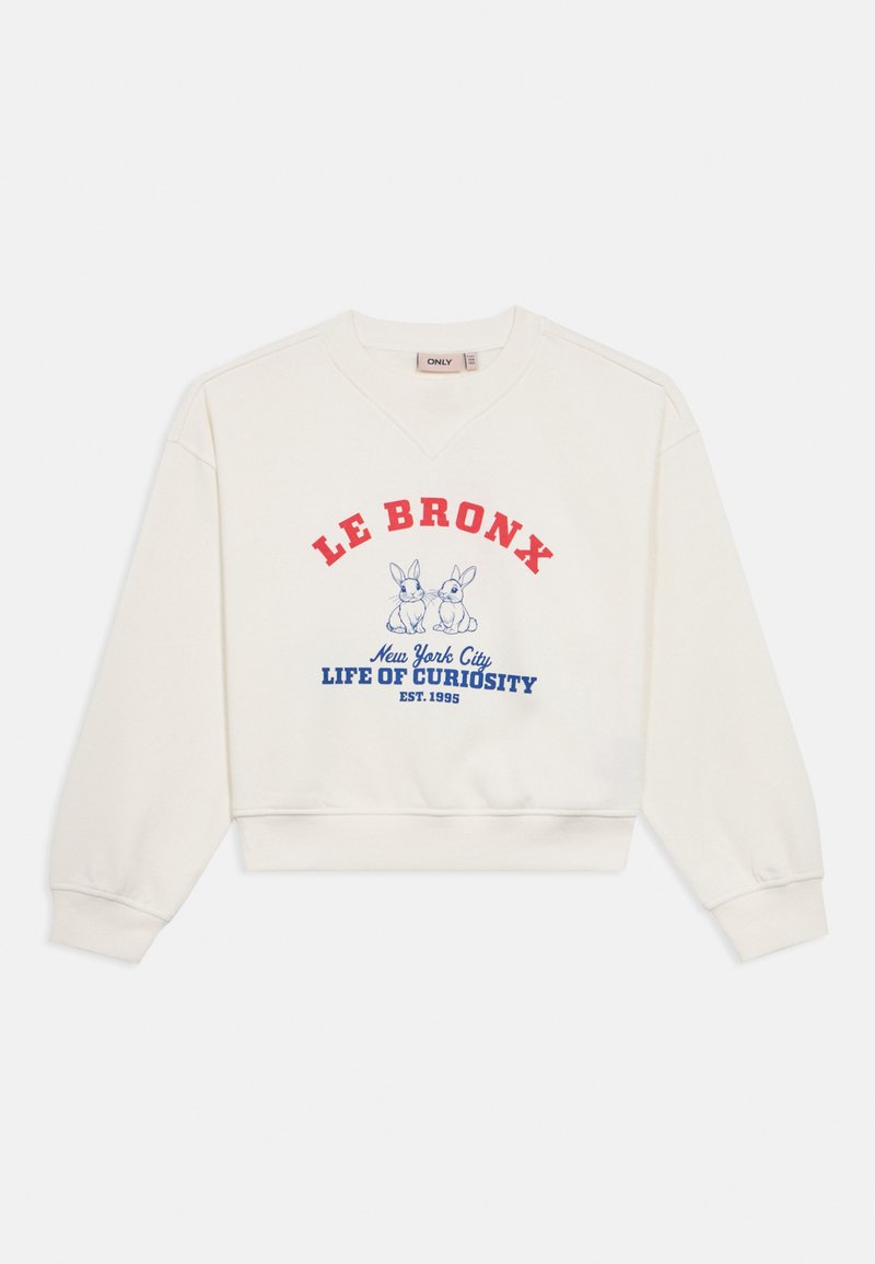 Sweatshirt cor de creme com design cropped. Apresenta texto vermelho e azul dizendo "LE BRONX, New York City, LIFE OF CURIOSITY" e duas ilustrações de coelhos.