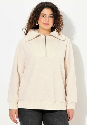 Cremfarbener Fleece-Pullover mit einem gerippten Kragen und einem Viertel-Reißverschluss. Besitzt einen strukturierten Körper und gerippte Bündchen an den Ärmeln und am Saum.