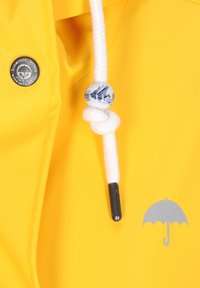 Rumena vodoodporna jakna z logotipom srebrne dežnike, belo vrvico z modrim dekorativnim biserom in kovinskim gumbom.