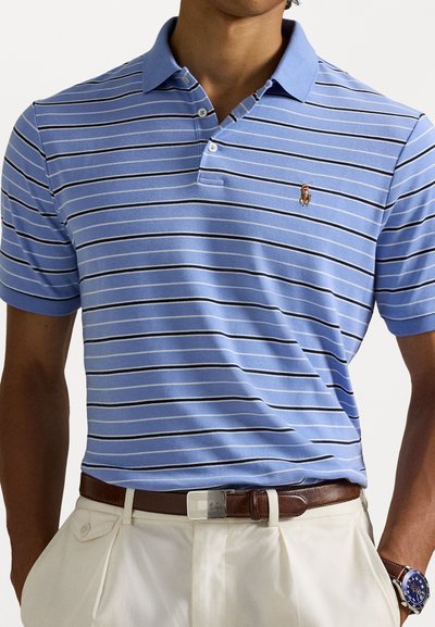 Ανοιχτού γαλάζιου χρώματος πόλο μπλουζάκι με οριζόντιες λευκές και μαύρες ρίγες. Διαθέτει τρία κουμπιά στο λαιμό και κεντημένο λογότυπο στο στήθος.