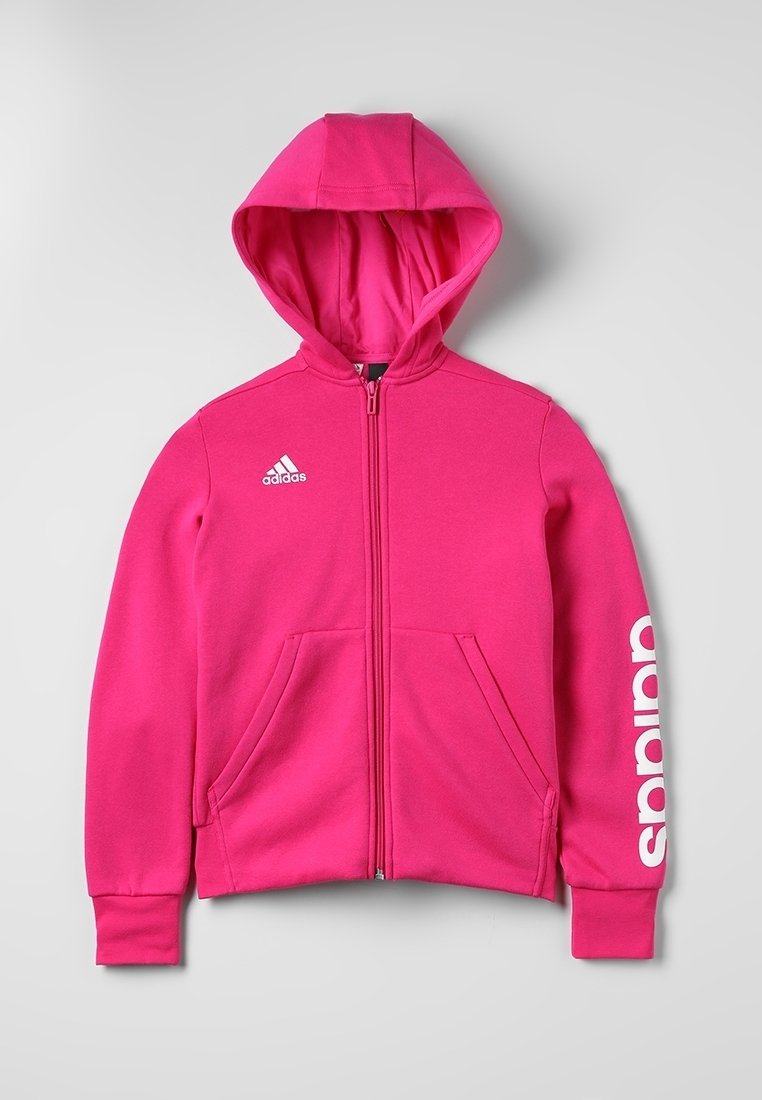 Ljusrosa zip-up hoodie med huva. Har framfickor och vit logotyp på ärmen. Tillverkad av mjukt, texturerat tyg.