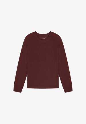 Burgundy long-sleeve top with round neckline, fitted cuffs, and side panel design. Made from soft, textured fabric.