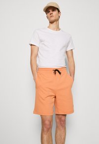 HUGO Treniņtērpa apakšdaļas - medium orange