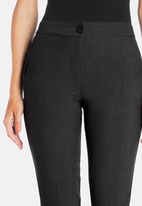 Black, tailored pants with a smooth, textured fabric, featuring a single button closure, straight leg design, and subtle side pockets.
