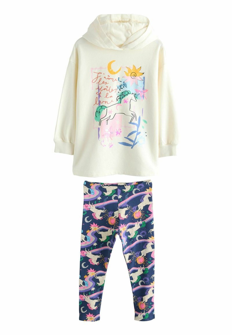 Cream-colored hoodie with unicorn graphic; soft fabric. Navy leggings with colorful unicorn and celestial pattern; stretchy fit.
