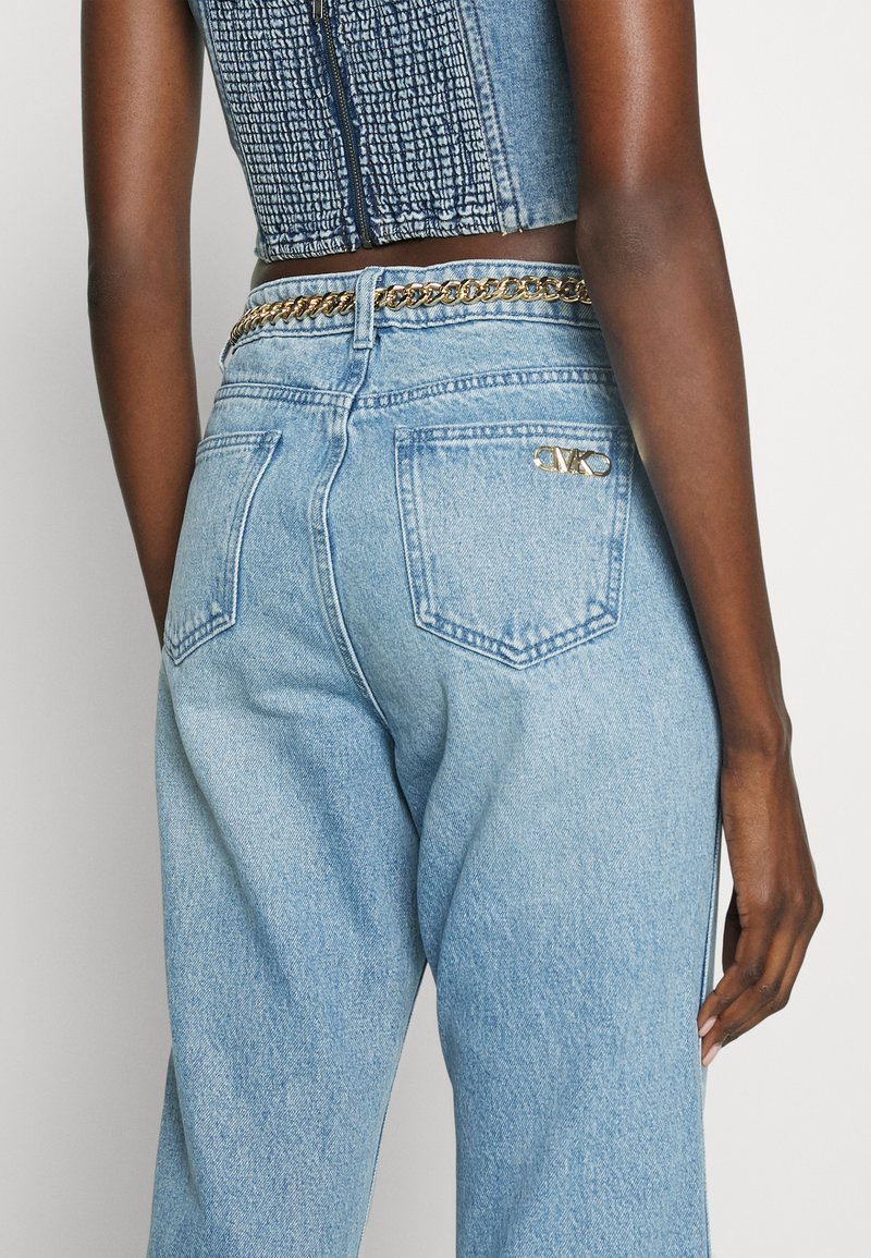 Jasnoniebieskie dżinsy z wysokim stanem o luźnym kroju, z tylkimi kieszeniami i złotym metalowym akcentem logo na prawej tylnej kieszeni.