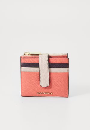 Compact leather wallet in coral and beige, featuring textured finish, multiple card slots, gold-tone hardware, and a zippered compartment.