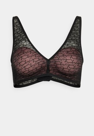 Bralette en dentelle noire transparente avec des bonnets rembourrés couleur mauve, présentant un motif abstrait noir répétitif et de larges bretelles.