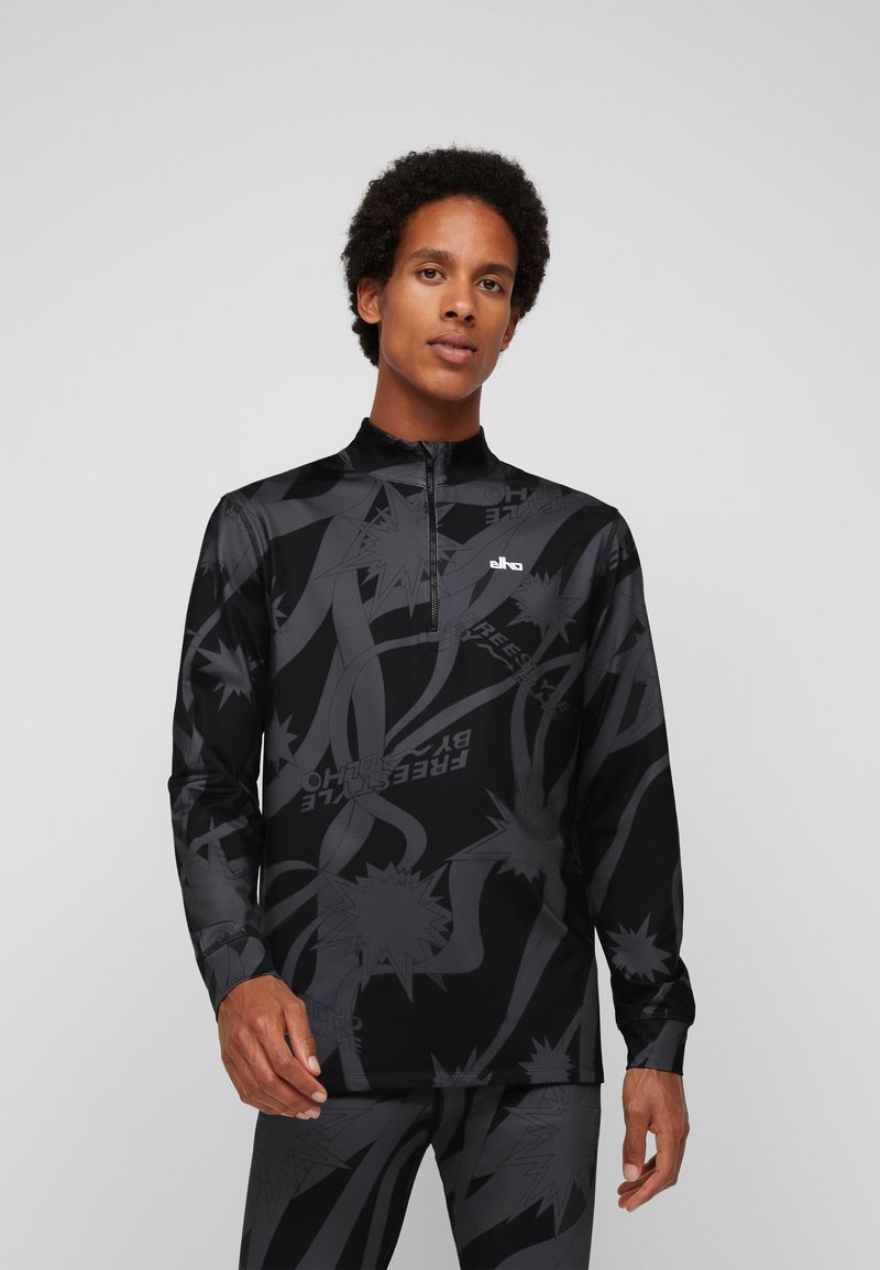 Schwarzes, langärmliges Sportoberteil mit hohem Kragen, Reißverschluss vorne und auffälligen grauen Grafikmustern. Hergestellt aus dehnbarem Stoff für einen hohen Tragekomfort.