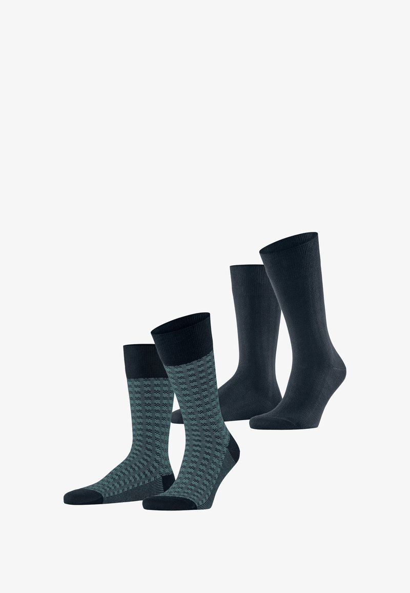 Chaussettes unies bleu marine et chaussettes à motifs teal avec une bordure bleu marine. Les chaussettes ont une texture lisse et sont de hauteurs variées.