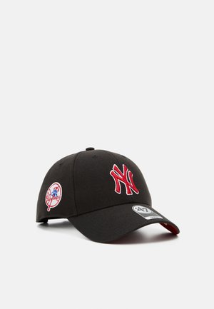 Black baseball cap with a curved brim, red embroidered New York Yankees logo, and side logo patch. Made of fabric with a smooth texture.