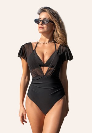 Maillot de bain une pièce noir avec des manches en voile à volants, décolleté en V profond et taille froncée. Il possède une texture lisse et un style minimaliste.