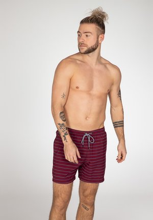 Rote und marine gestreifte Badehose mit elastischem Bund und grauem Kordelzug, aus leichtem Stoff gefertigt und mit einer lockeren Passform.