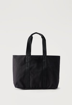 Zwarte draagtas met twee geborduurde handvatten en een subtiel "HUGO"-logo gecentreerd aan de voorkant, rechtopstaand op een effen achtergrond.