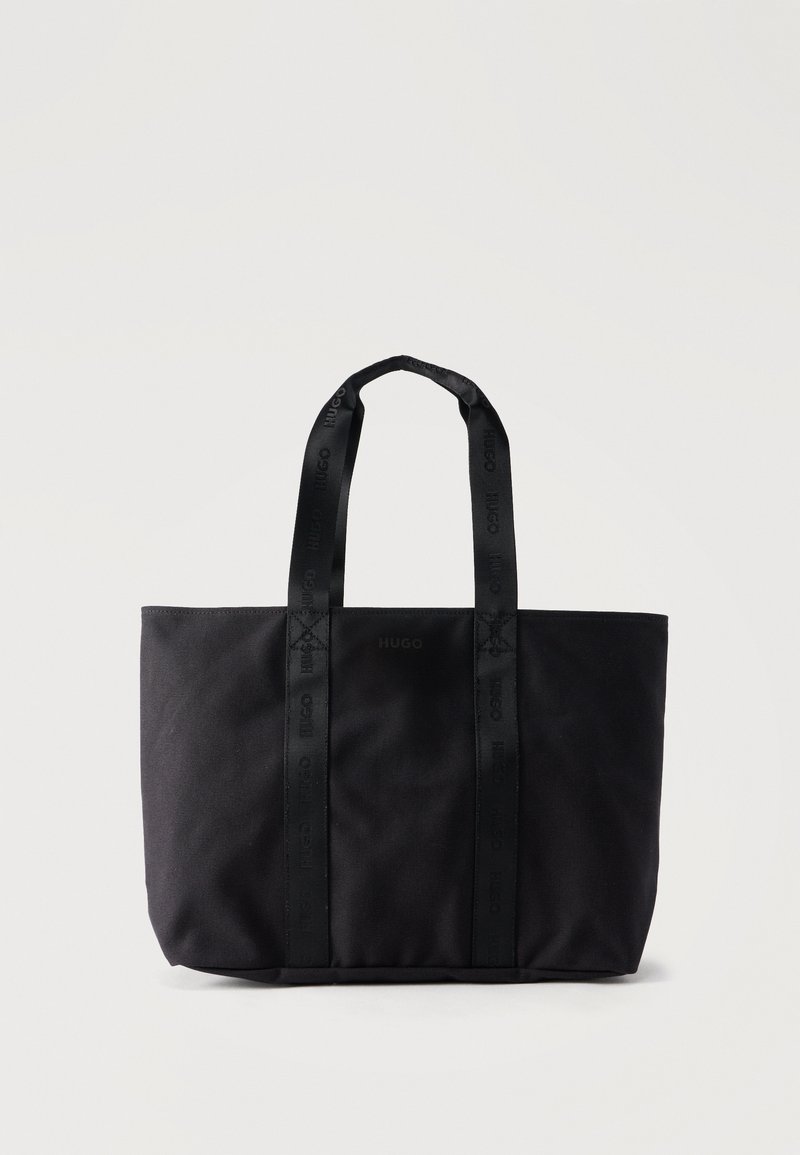 Sac fourre-tout noir avec deux poignées de marque et un logo "HUGO" discret centré à l'avant, posé debout sur un fond uni.