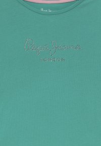 Teal crew-neck t-paita, jossa on sileä pinta ja rintamalla "Pepe Jeans London" hopeisista strasseista.