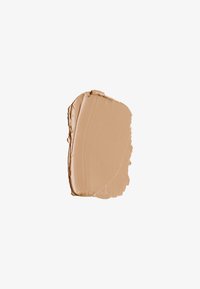 Crème de fond de teint beige avec une texture lisse, présentée sous forme d'une épaisse application. La couleur est uniforme et a un léger éclat, avec un bord net.