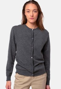 Grauer Cardigan aus weichem Stoff, mit Rundhalsausschnitt, langen Ärmeln und fünf lila Knöpfen auf der Vorderseite.