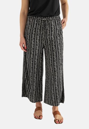 Pantalons larges en noir et blanc avec un motif de rayures florales verticales, dotés d'une taille élastique et d'un cordon de serrage, fabriqués en tissu léger.
