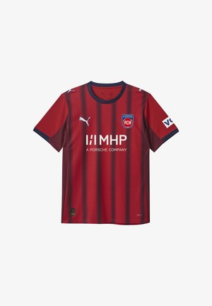 Rode voetbalshirt met donkere verticale strepen, ronde hals en korte mouwen. Bevat het Puma-logo, sponsortekst en clubembleem op de borst.