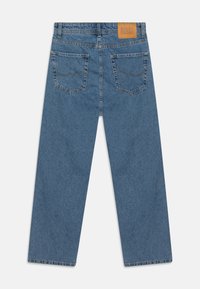 Blue denim jeans with a relaxed fit, straight legs, two back pockets, and a brown leather brand patch on the waistband.