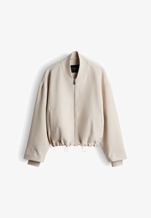 Beige bomber jacket with a zip front, ribbed collar, and drawstring hem. Features side pockets and a smooth texture.