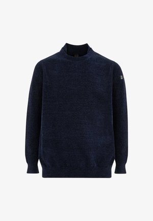 Maglione blu navy con collo alto, polsini e orlo a costine. Realizzato in tessuto a maglia strutturata, presenta un piccolo logo sulla manica.