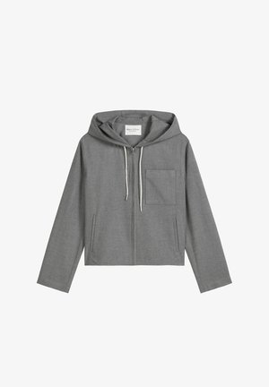 Szara krótka bluza z kapturem wykonana z teksturowanej tkaniny, wyposażona w przedni zamek błyskawiczny, sznurki i pojedynczą kieszeń na piersi. Posiada długie rękawy.