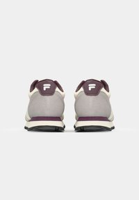 Sport shoes featuring a light gray upper with dark purple accents, white branding, cushioned heel, and a textured black outsole.