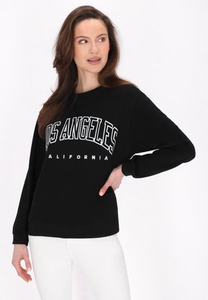 Sort sweatshirt med lange ærmer, der har "LOS ANGELES" og "CALIFORNIA" trykt i hvidt. Casual pasform, rund halsudskæring, blød tekstur.