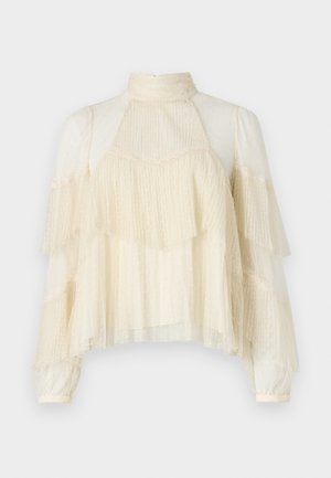 Cream-colored blouse with layered ruffles, sheer polka dot texture, high neck, and long sleeves, featuring delicate lace accents.