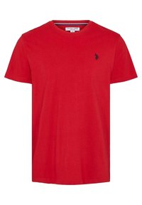 Red short-sleeve crew neck T-shirt with small black embroidered polo player logo on left chest, label inside collar showing brand and size.