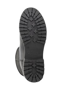 Zwarte rubberen zool van een laars met diepe profiel, kruisspatronen, maat "39" aanduiding en het logo "TRAVELIN Where we walk".