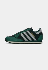 Green and black athletic shoe with a suede and mesh upper. Features three white stripes, black laces, and a textured rubber sole.