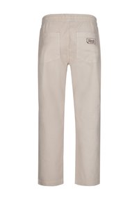 Beige katoenen broek met een elastische tailleband, voorzien van twee achterzakken en een logo-opdruk boven de rechterzak. Rechthoekige pasvorm.
