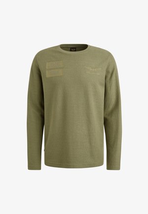 Chemise à manches longues vert olive en tissu texturé, dotée de deux écussons et d'une marque brodée sur la poitrine. Encolure ronde.