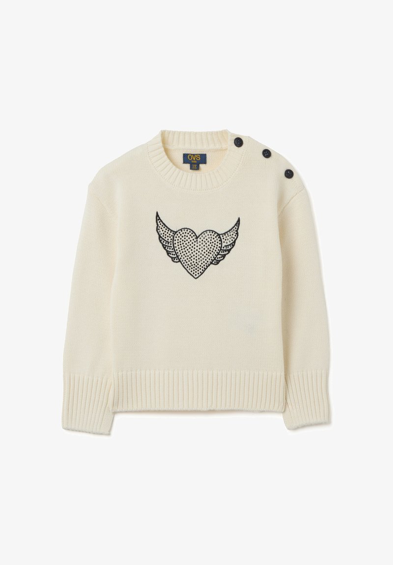 Maglione lavorato a maglia color crema con polsini e orlo a coste, caratterizzato da un design a cuore alato nero sulla parte anteriore e tre bottoni neri funzionali.