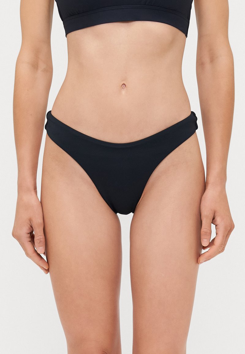 Black bikini bottom with a seamless design. The fabric is smooth and stretchy, featuring a high-cut leg and a folded waistband for added comfort.