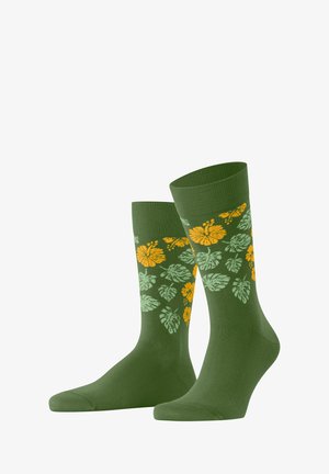 Grüne Socken mit einem gerippten Bund, die mit gelben und hellgrünen Blumen- und Blattmustern verziert sind. Aus weichem Material, knielange Ausführung.