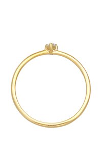 Gold ring featuring a thin band with a smooth texture and a small clear gemstone set centrally at the top.