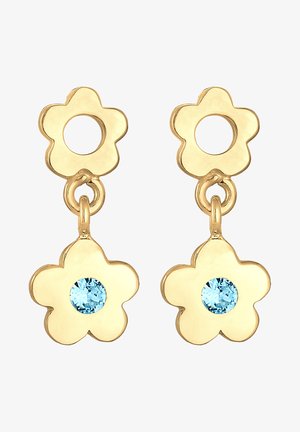 Boucles d'oreilles en forme de fleur en or avec une pierre centrale bleu clair, dotées d'une ouverture ronde en haut pour la fixation. Texture lisse, design ludique.